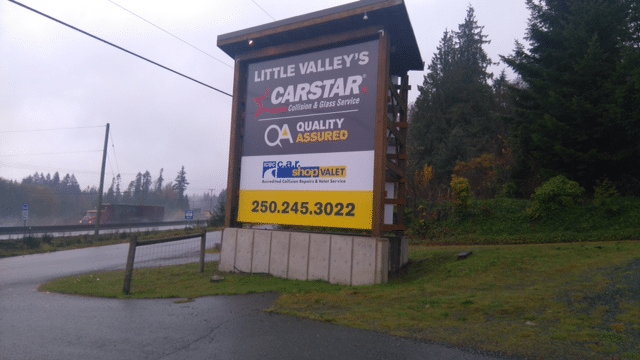 Roadside sign for Little Valley Auto Body Repair Shop in Ladysmith BC