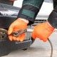 Gloved hands hooking a tow rope to a vehicle