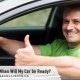 Smiling man at the wheel of a car giving Thumbs Up